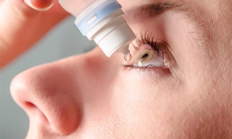 Close Up View Of Young Woman Applying Eye Drop To Left Eye Artificial Tears Antibiotics Antihistamine