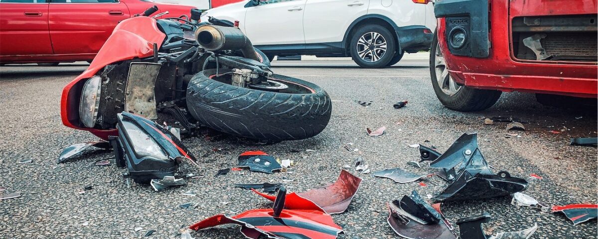 Motorcycle Bike Accident And Car Crash Broken And Wrecked Moto On Road